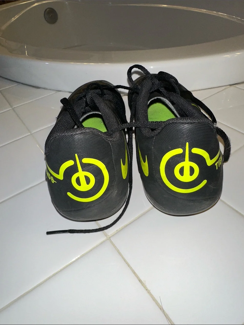 Nike Black youth Athletic cleat Shoes with Volt Swoosh